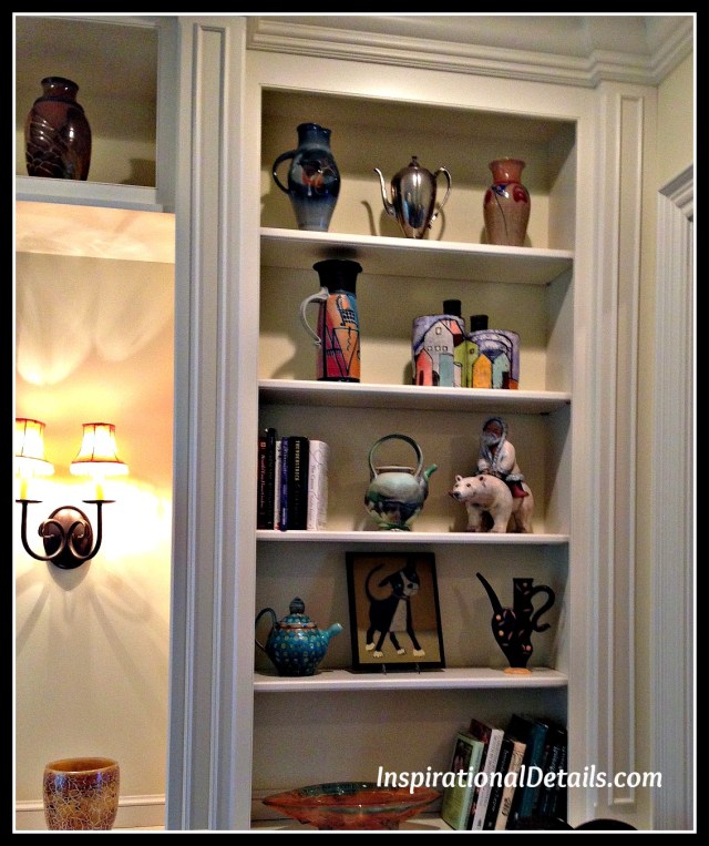arranging shelves with art pieces